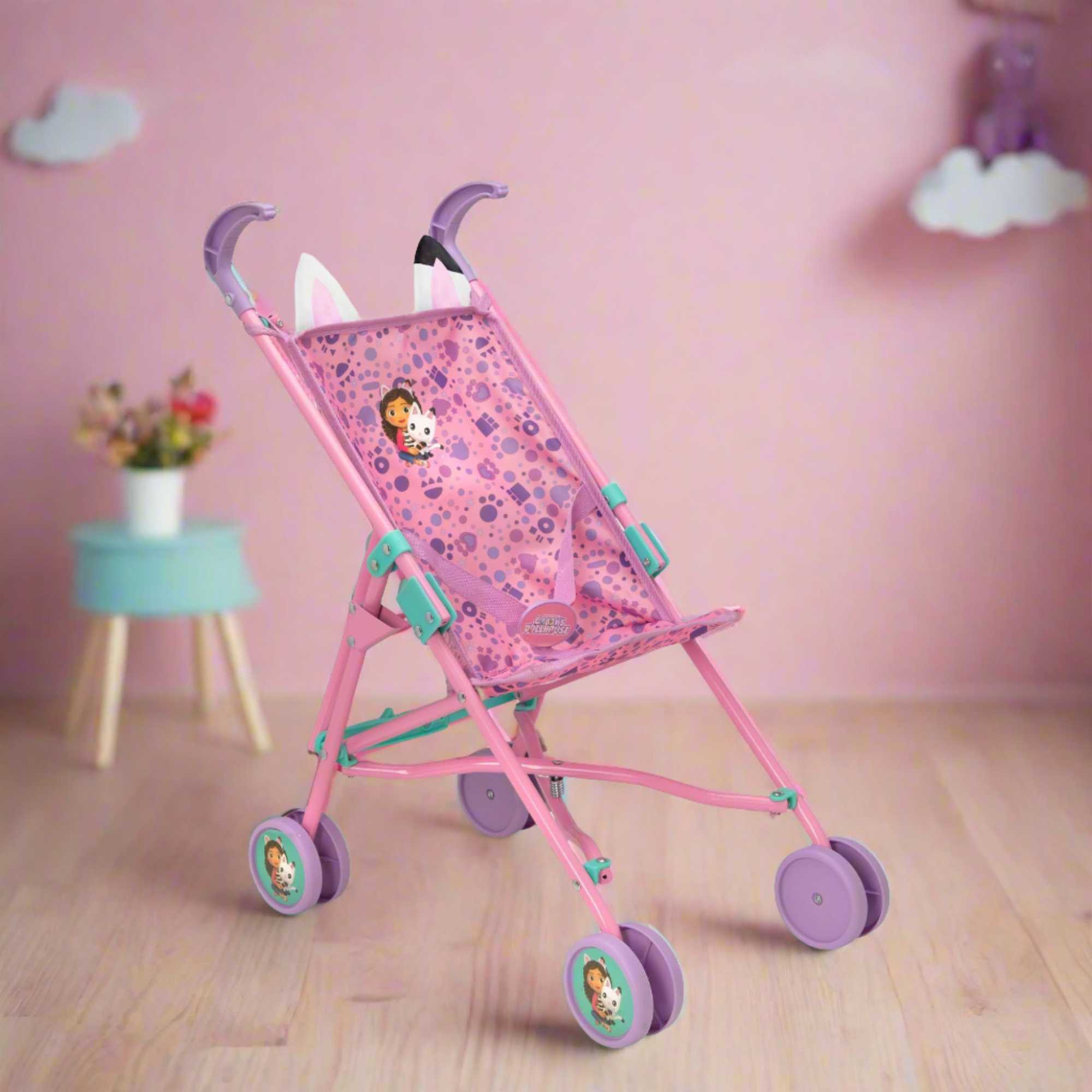 Colourful toy stroller featuring popular characters from Gabby's Dollhouse, designed for children to enjoy pretend play. Ideal for carrying dolls and other small toys, with vibrant designs and sturdy wheels for easy manoeuvrability.