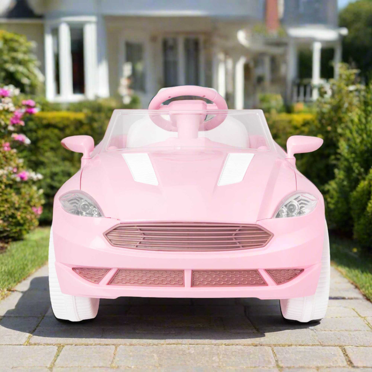 Pink EVO Dream Coupe Car Ride-On Toy for children aged 3+, featuring pedal-driven forward and reverse motion, working headlights, and authentic engine and horn sounds