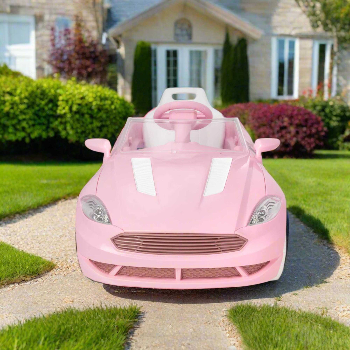 Pink EVO Dream Coupe Car Ride-On Toy for children aged 3+, featuring pedal-driven forward and reverse motion, working headlights, and authentic engine and horn sounds