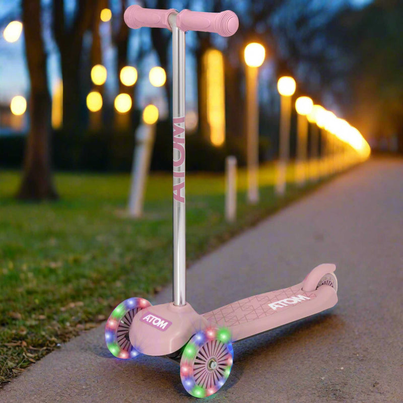 ATOM Move N Groove Light Up 3-wheeled scooter with flashing LED wheels, colourful design, and tilt to steer system, offering a fun and stable ride for children.