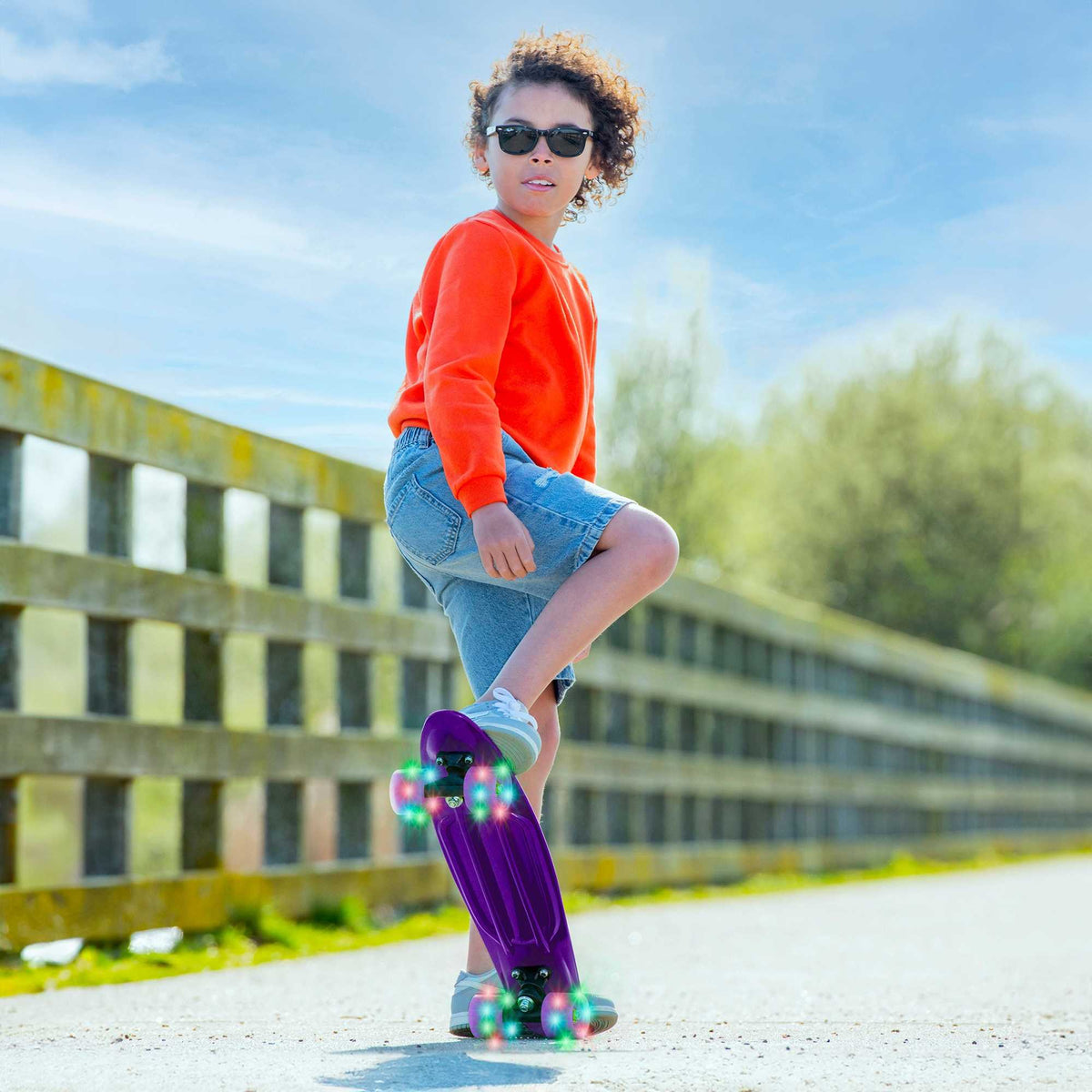 Children’s EVO 22-inch Penny Board with light-up wheels, showcasing a compact design and vibrant retro style, perfect for young riders. The board features a textured grip surface and smooth, illuminated wheels that light up during movement. 