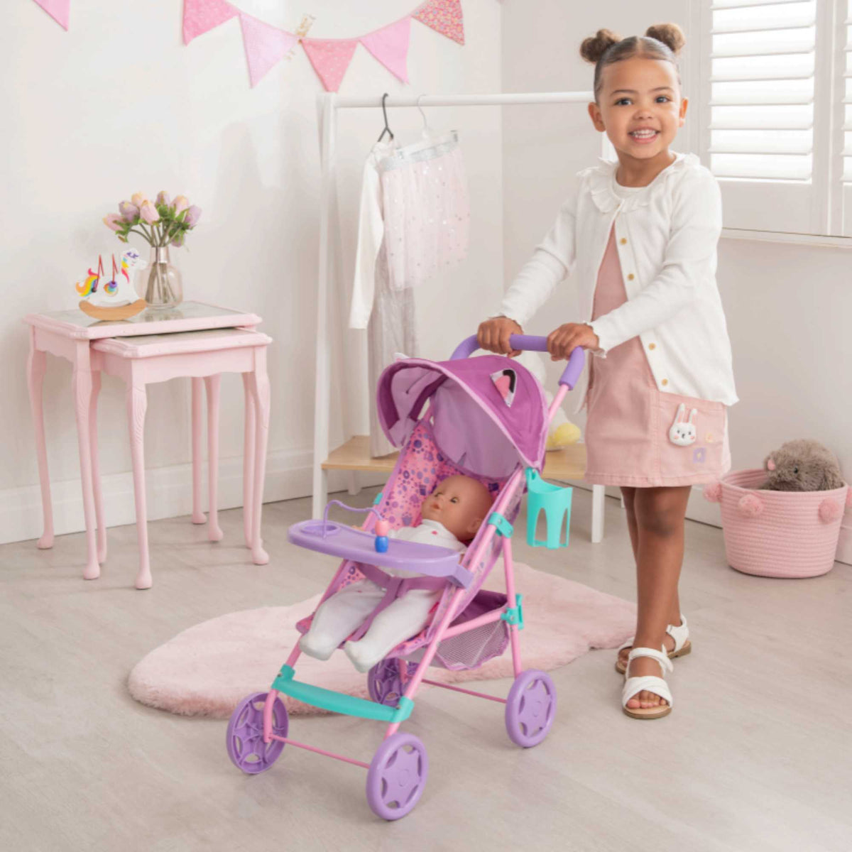 Bright and fun toy pushchair inspired by Gabby&#39;s Dollhouse, ideal for kids to push their favourite dolls and toys. Features a durable frame, smooth-rolling wheels, and colourful designs with beloved characters from the series.