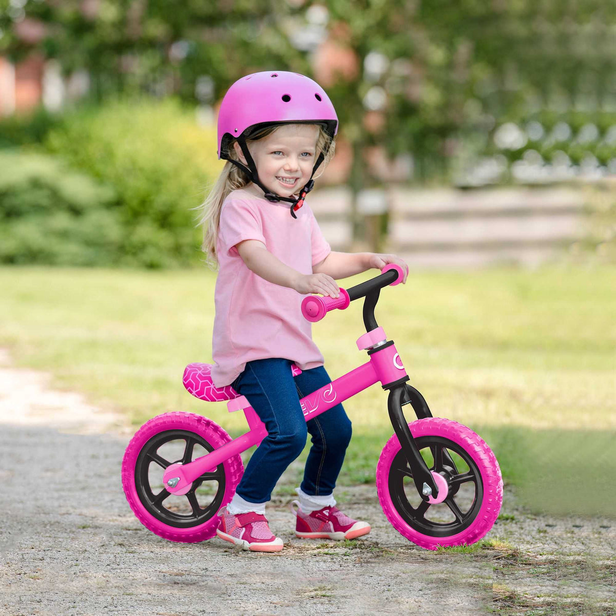 Child riding the EVO Balance Bike outdoors, showcasing the lightweight and durable design perfect for young learners to develop their balance and coordination skills