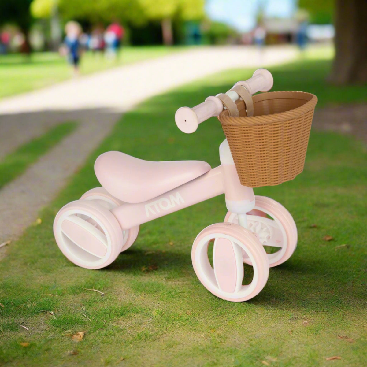 pink toddlers bobble bike with a wicker basket.