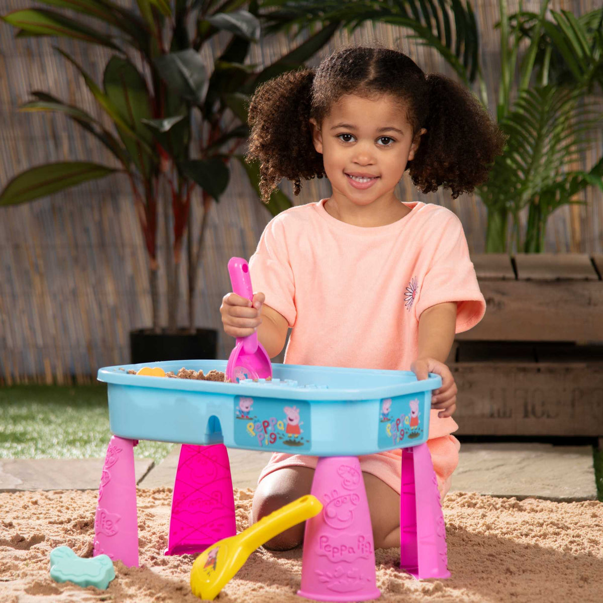 Peppa Pig Sand &amp; Water Play Table with fun accessories for kids, featuring separate sand and water compartments, perfect for outdoor sensory play and Peppa Pig fans.