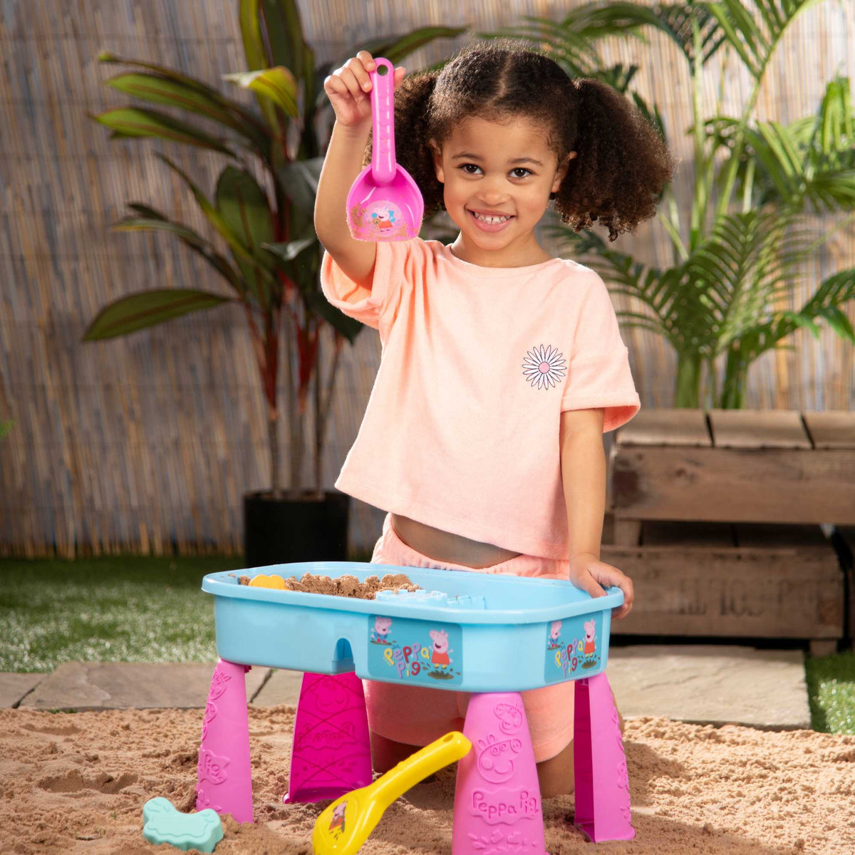 Peppa Pig Sand &amp; Water Play Table with fun accessories for kids, featuring separate sand and water compartments, perfect for outdoor sensory play and Peppa Pig fans.