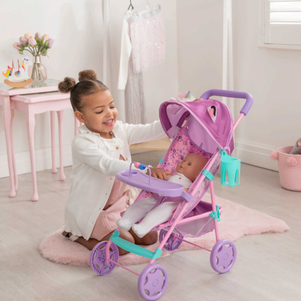 Bright and fun toy pushchair inspired by Gabby&#39;s Dollhouse, ideal for kids to push their favourite dolls and toys. Features a durable frame, smooth-rolling wheels, and colourful designs with beloved characters from the series.