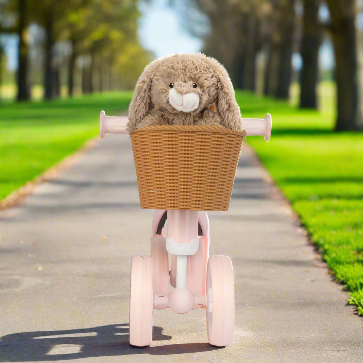 pink toddlers bobble bike with a wicker basket.