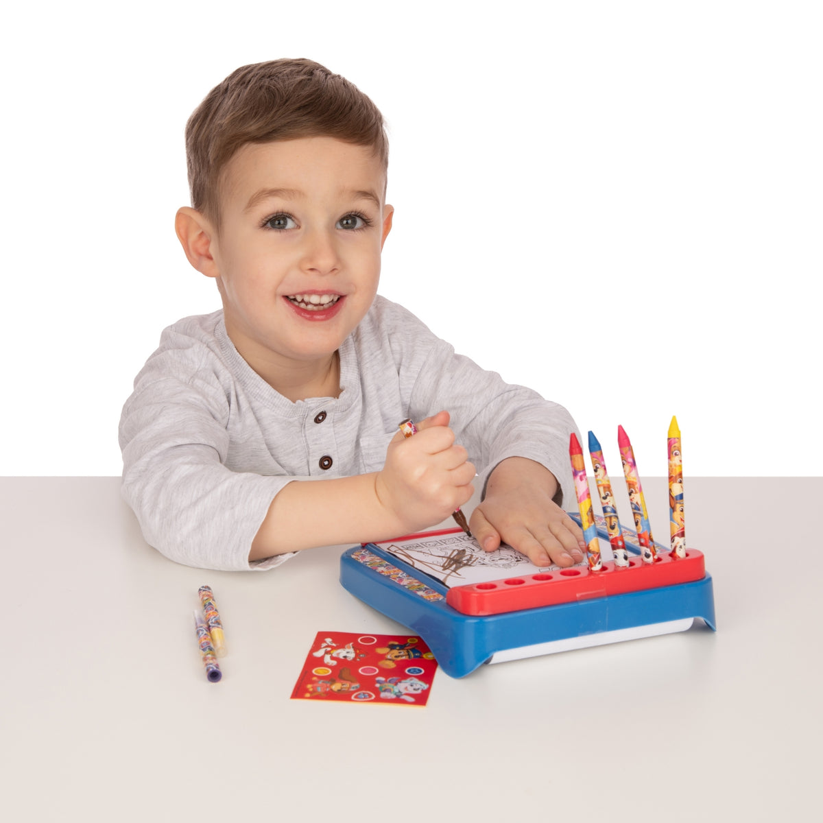 Child playing with a colourful educational toy on a white background