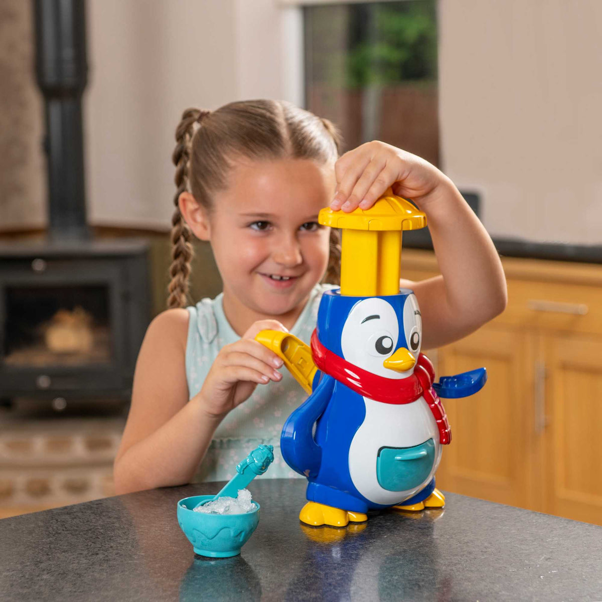 Polar Penguin Ice Maker Toy Set featuring a penguin-shaped ice crusher, ice lolly moulds, ice cube tray, and a bottle for syrups. Perfect for kids, this fun and educational set allows them to create delicious frozen treats, promoting creativity and learning about the science of freezing. 