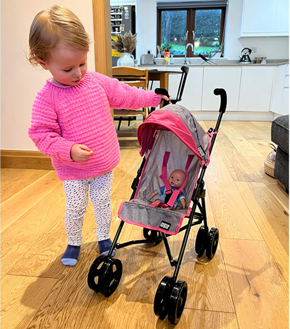 Mamas &amp; Papas Junior Cruise Stroller, designed for children&#39;s imaginative play, featuring a sleek and modern design with sturdy frame and smooth-rolling wheels, perfect for pretend outings with dolls.