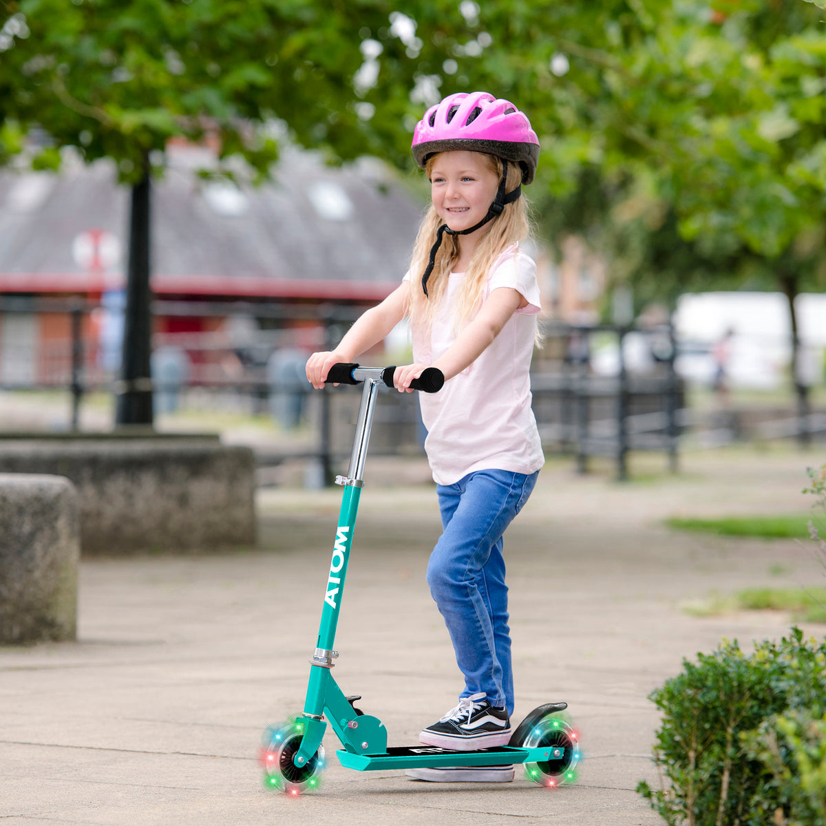 ATOM Inline Children&#39;s Kick Scooter in bright colours, designed for kids with a sturdy frame, adjustable handlebars, and smooth-rolling wheels, perfect for outdoor fun and active play.