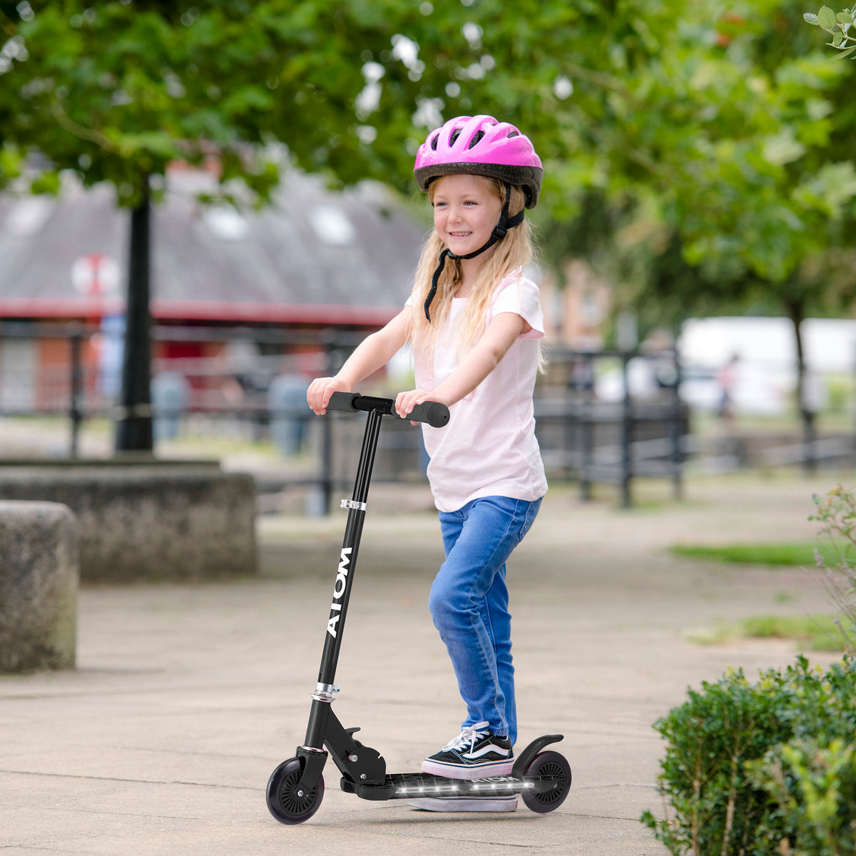 ATOM Night Flash 2-wheeled scooter for kids aged 5 and up, featuring LED light-up wheels, a sturdy frame, and adjustable handlebars, designed for safe and exciting rides.