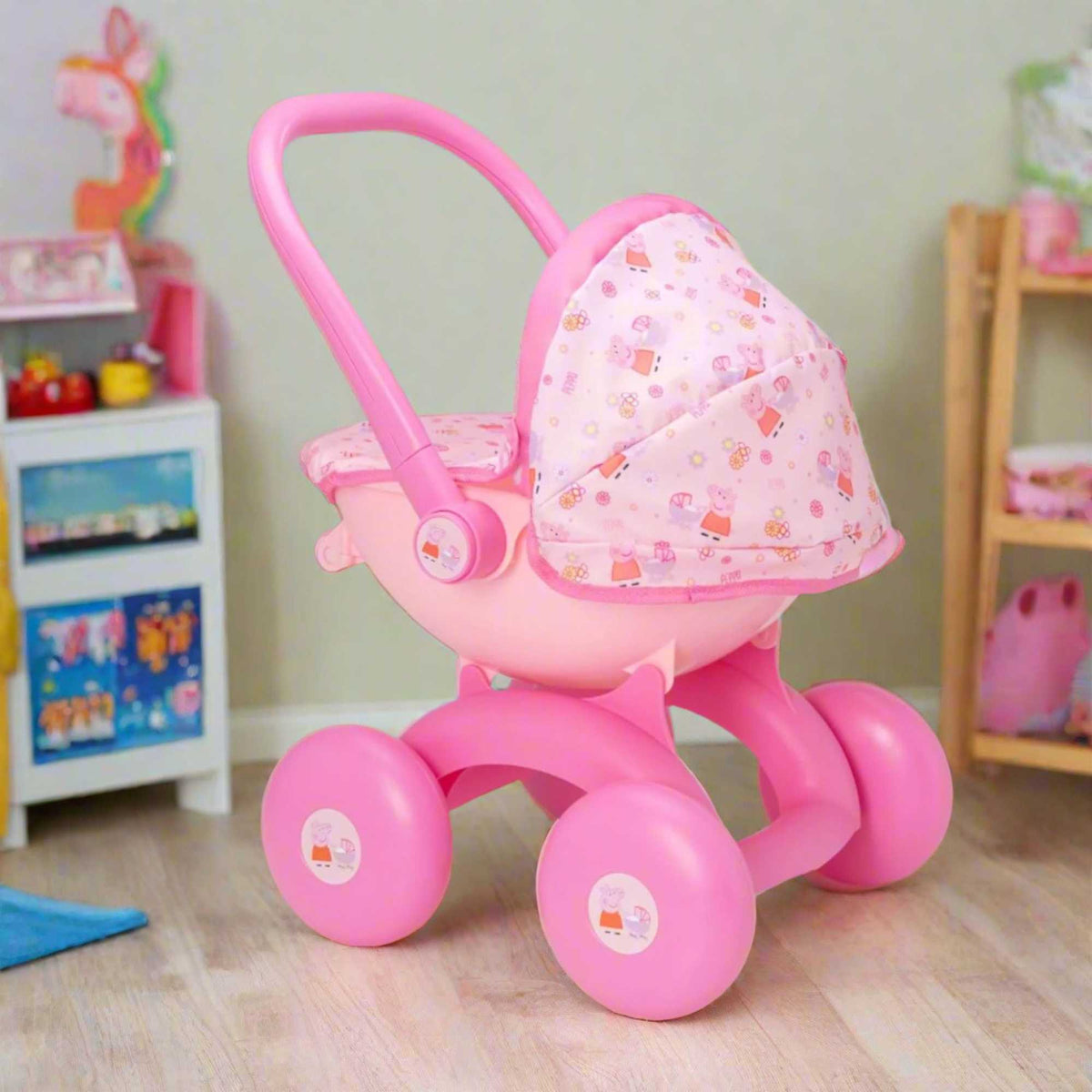 Peppa Pig 4-IN-1 My First Pram: A pink and white toy pram featuring Peppa Pig graphics, designed for toddlers with four versatile play modes, perfect for imaginative play and doll carrying.