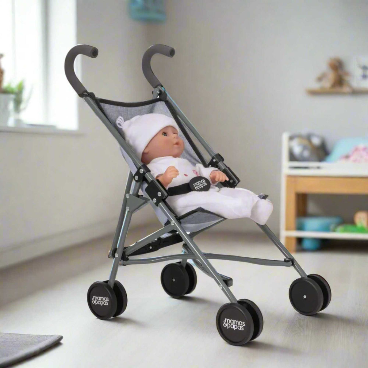 Mamas &amp; Papas Junior Doll Stroller in grey, featuring a foldable and lightweight design for easy storage and portability, ideal for children&#39;s imaginative play with dolls.