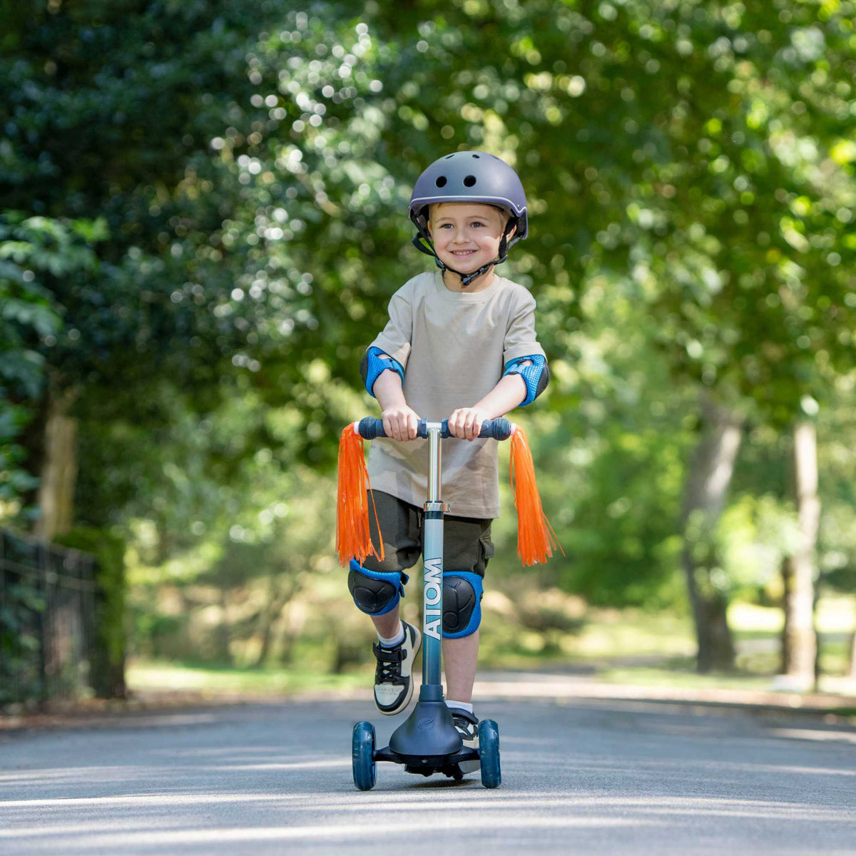 ATOM Eclipse Kids 3 Wheeled Scooter in vibrant solar theme, featuring a sturdy design, bright colors, and a space-inspired pattern perfect for young riders