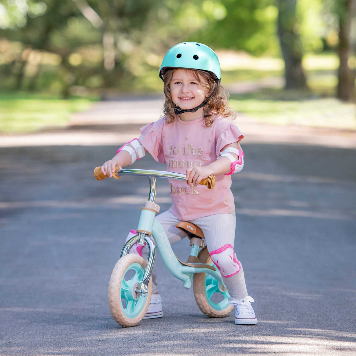 ATOM 10-inch Glider Bike in Mint Green, lightweight kids&#39; balance bicycle with adjustable seat and handlebars.