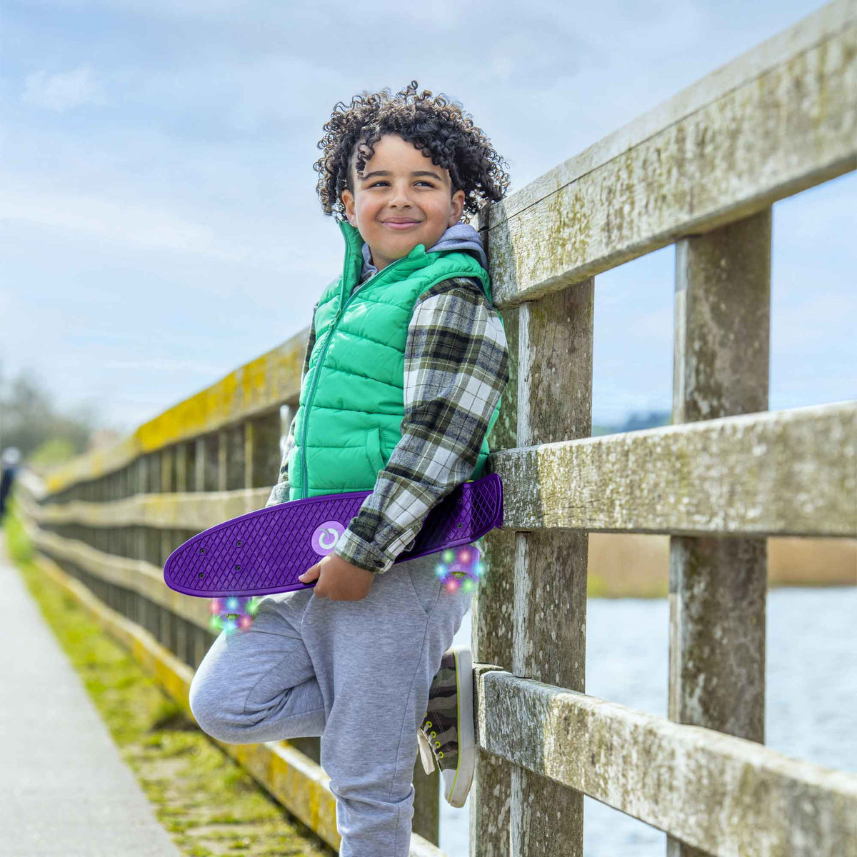 Children’s EVO 22-inch Penny Board in pink with light-up wheels, showcasing a compact design and vibrant retro style, perfect for young riders. The board features a textured grip surface and smooth, illuminated wheels that light up during movement. 