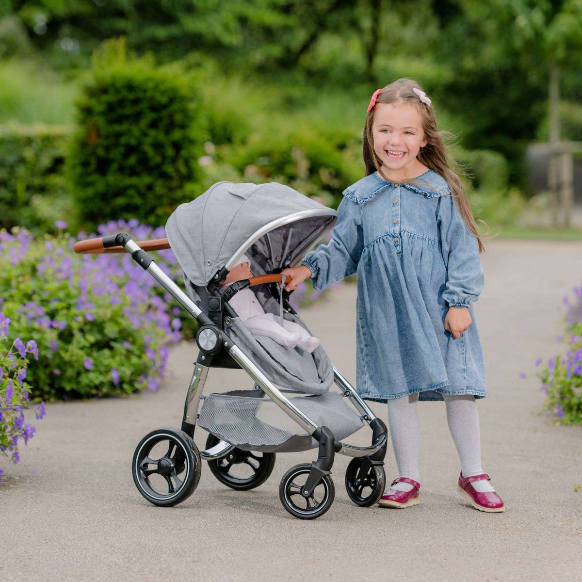 Mamas &amp; Papas Premium Occaro Pram set, a stylish dolls stroller with an adjustable hood, premium fabric, chunky chrome frame, and leather handles. Features front swivel wheels and folds flat for easy storage, mimicking the real-life version.